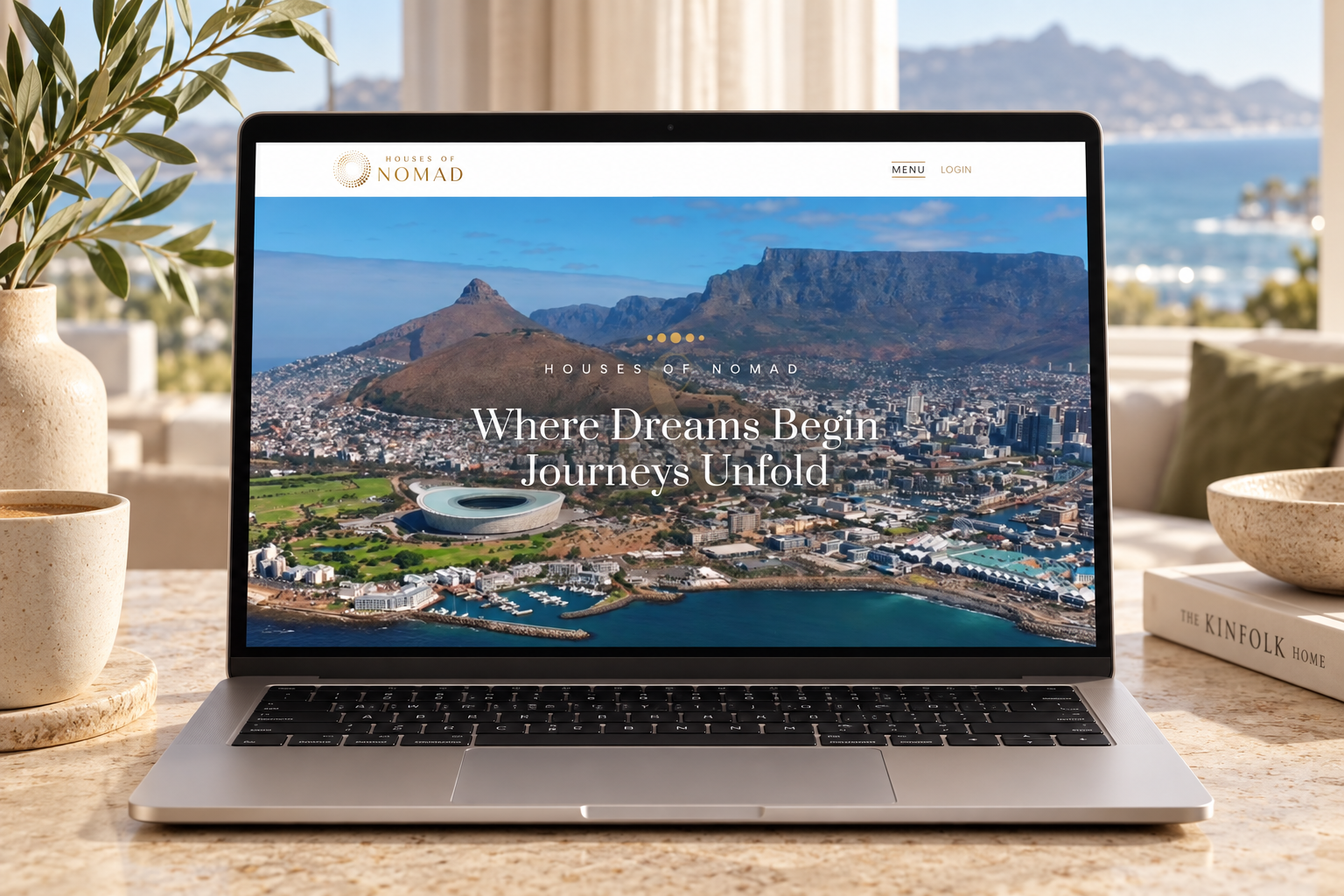 Houses of Nomad public homepage displayed on a laptop in a coastal interior concept